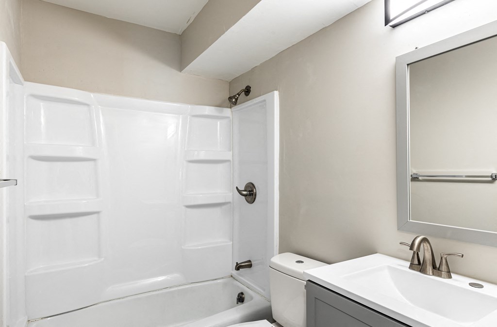 a bathroom with a sink and a toilet and a shower