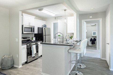 an open kitchen and dining area with a large counter top