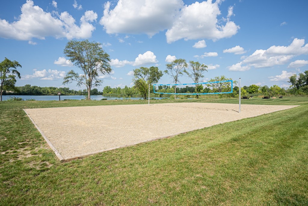 Outdoor sand volleyball court. Large grassy area sur