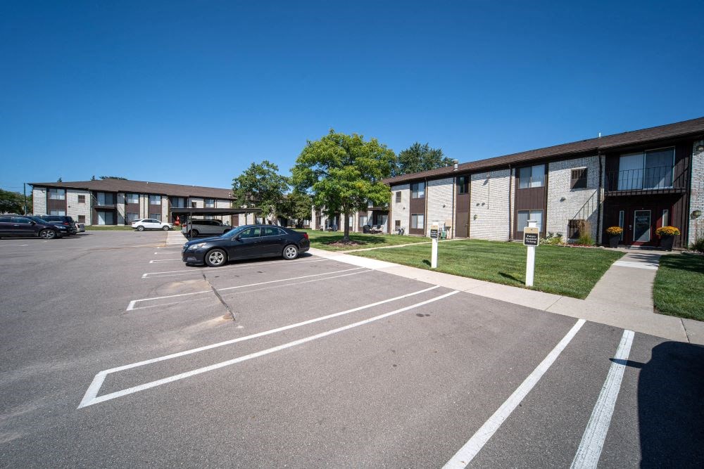 a parking lot with a car parked in front of a building