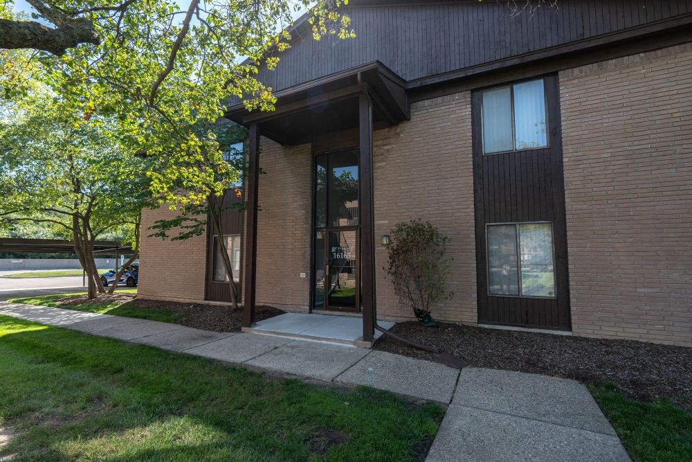 a brick building with a tree in front of it