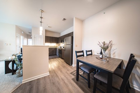 a dining room and kitchen with a table and chairs