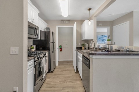 a kitchen with stainless steel appliances and a counter top