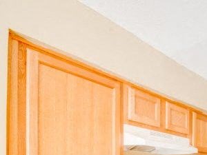 Kitchen with tan cabinets and white appliances. - Photo Gallery 6