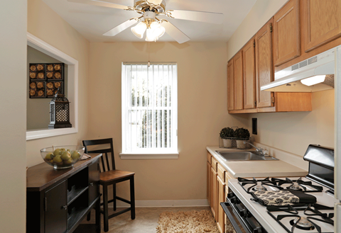 a kitchen with a stove top oven next to a window