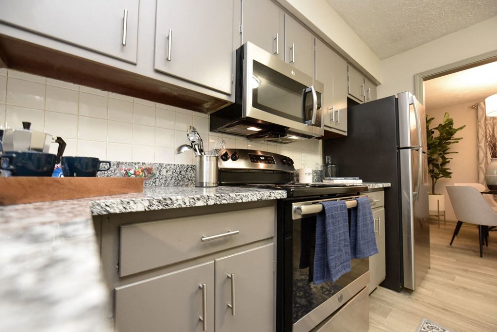 a kitchen with stainless steel appliances and granite counter tops