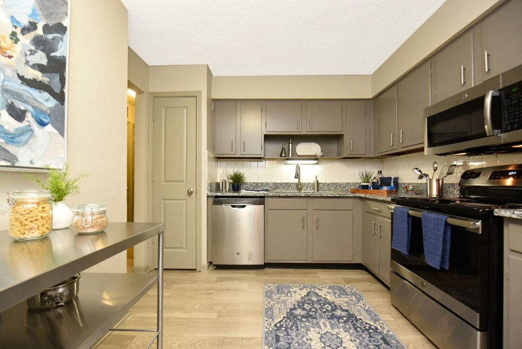 a kitchen with stainless steel appliances and granite counter tops