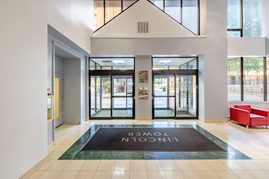 a lobby with a rug that says in the center of