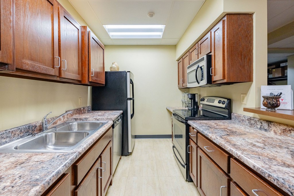 a kitchen with granite counter tops and stainless steel appliances