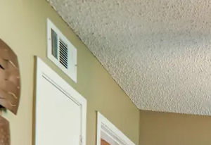 Hardwood like flooring with large window and ceiling fan.