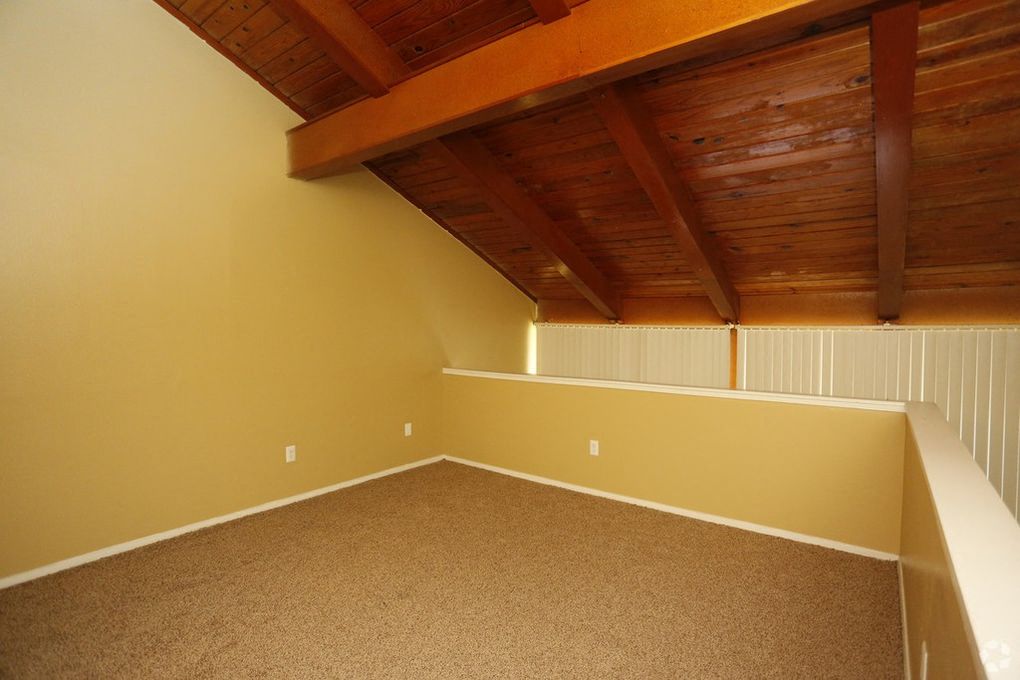Loft area with wooden ceiling.