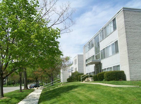 Charlton Apartments exterior with sidewalk and trees - Photo Gallery 1
