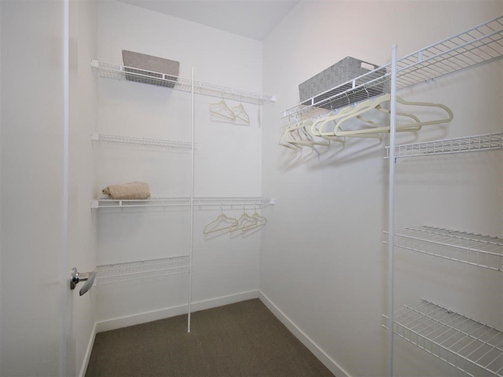 a walk in closet in a bedroom a walk in closet in a bedroom at The George, Ann Arbor