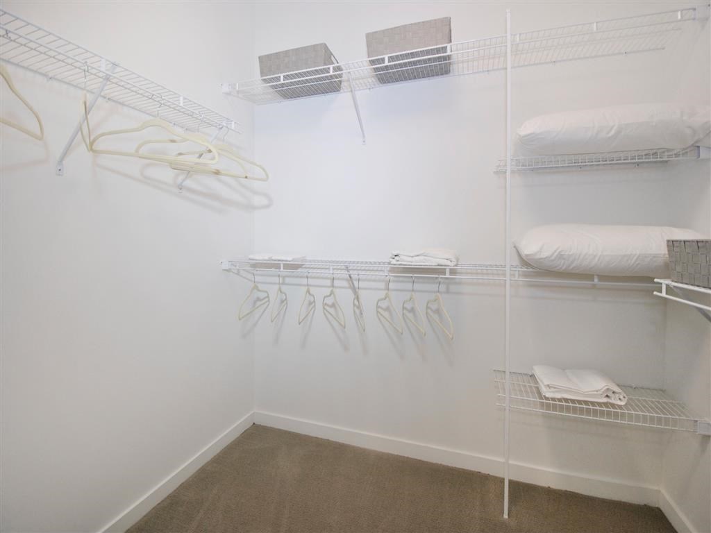 a bedroom with a bed and a closet a bedroom with a bed and a closet at The George, Ann Arbor Michigan