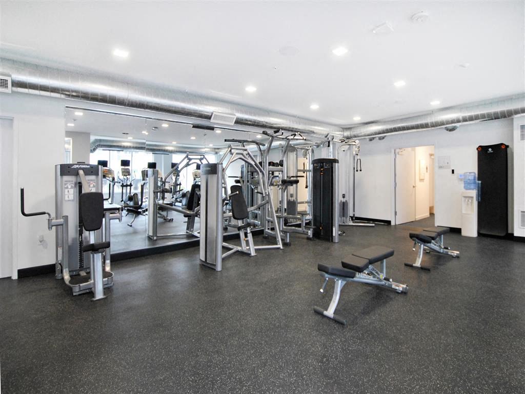 a gym with a lot of exercise equipment in it a gym with a lot of exercise equipment in it at The George, Ann Arbor, MI 48104