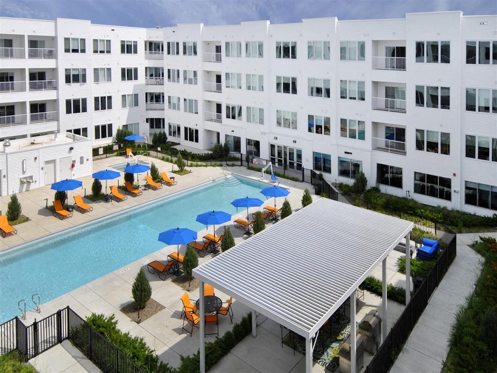 a large white building with a swimming pool in front of it a large white building with a swimming pool in front of it at The George, Ann Arbor, MI