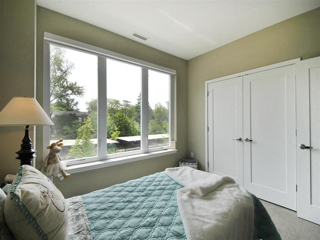 a bedroom with a large window and a bed a bedroom with a large window and a bed at The George, Michigan