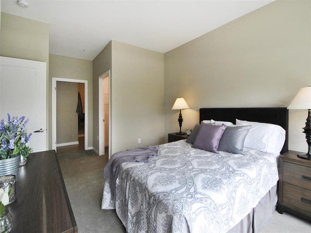 a bedroom with a bed and two night stands a bedroom with a bed and two night stands at The George, Michigan, 48104