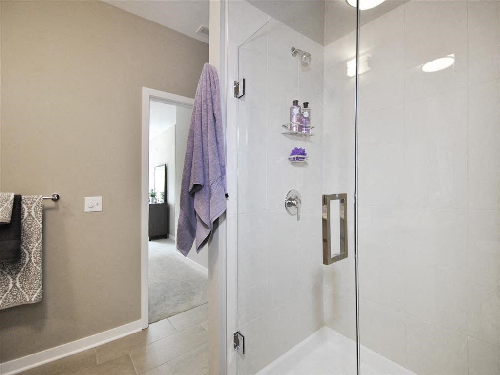 a bathroom with a glass shower door and a purple towel a bathroom with a glass shower door and a purple towel at The George, Ann Arbor, MI 48104