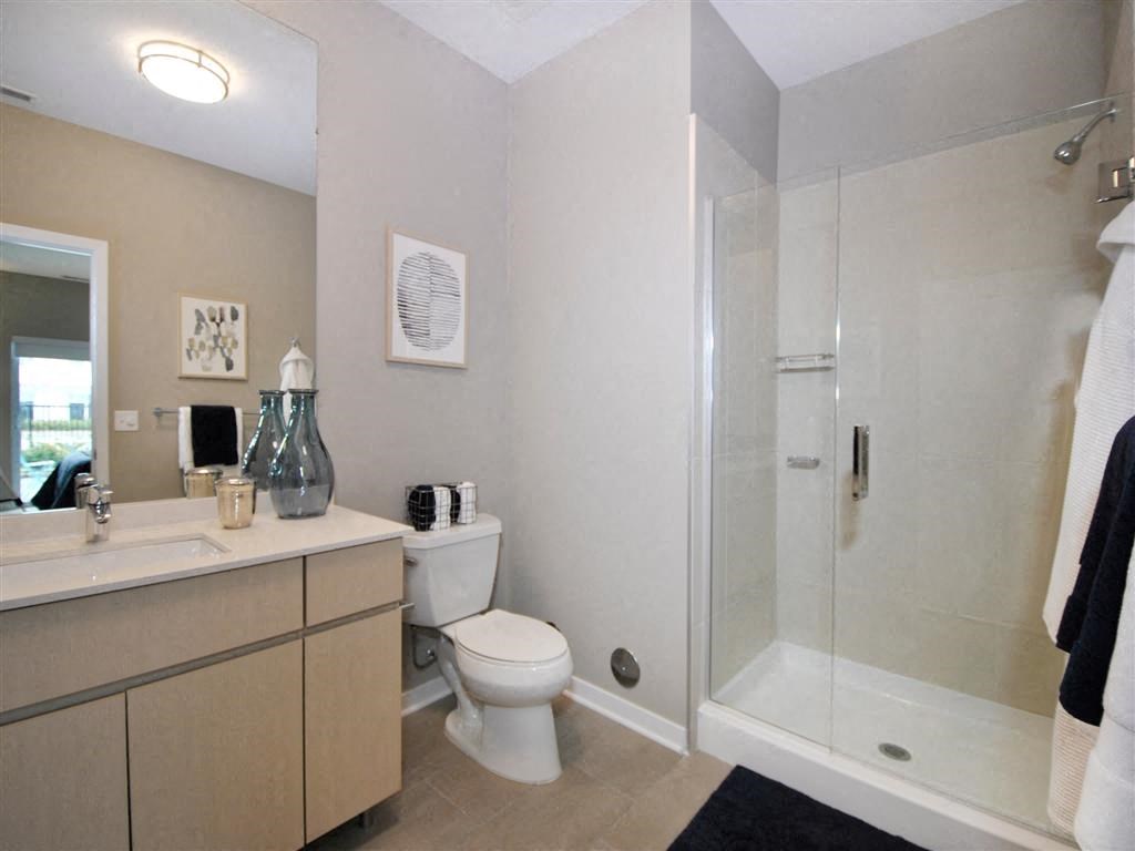 a bathroom with a toilet sink and shower a bathroom with a toilet sink and shower at The George, Ann Arbor
