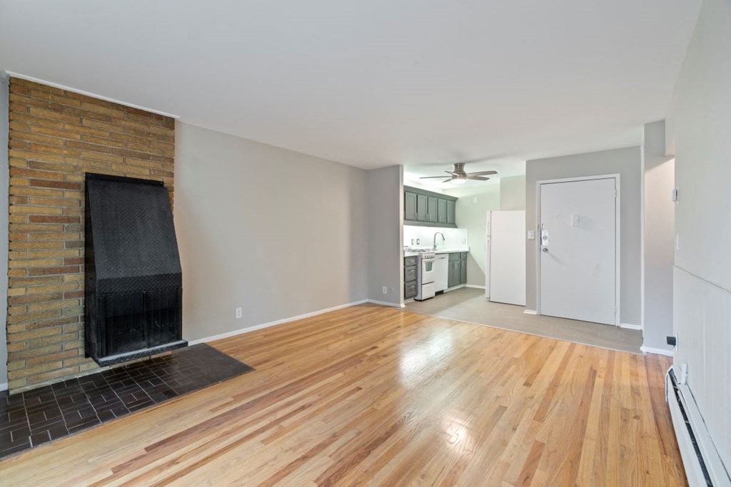 a living room with a fireplace and wooden floors