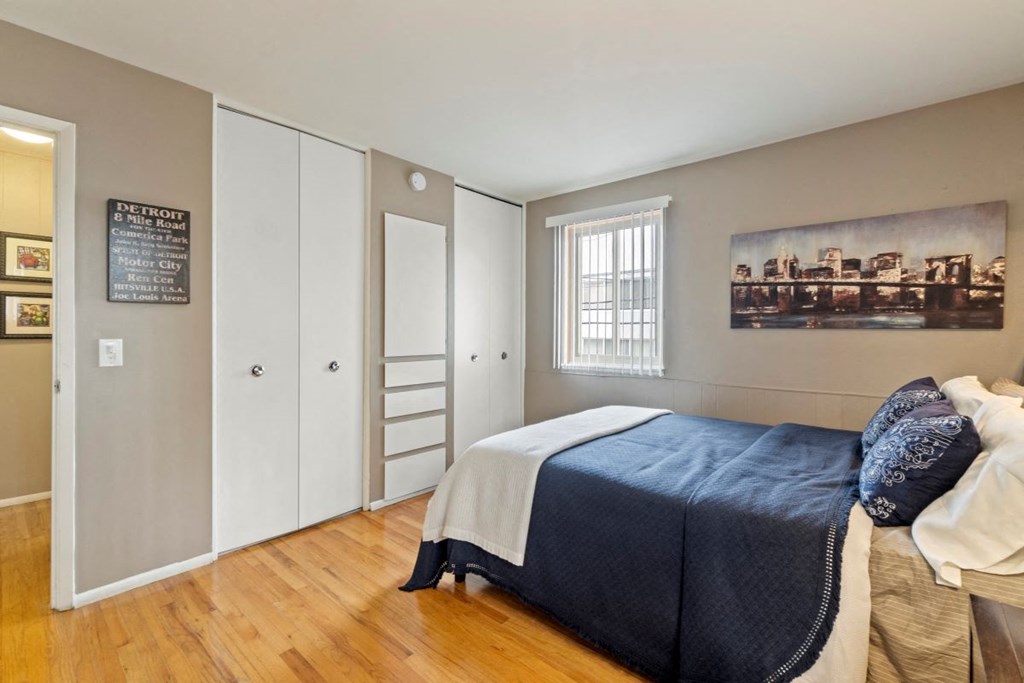 a bedroom with a bed and a window