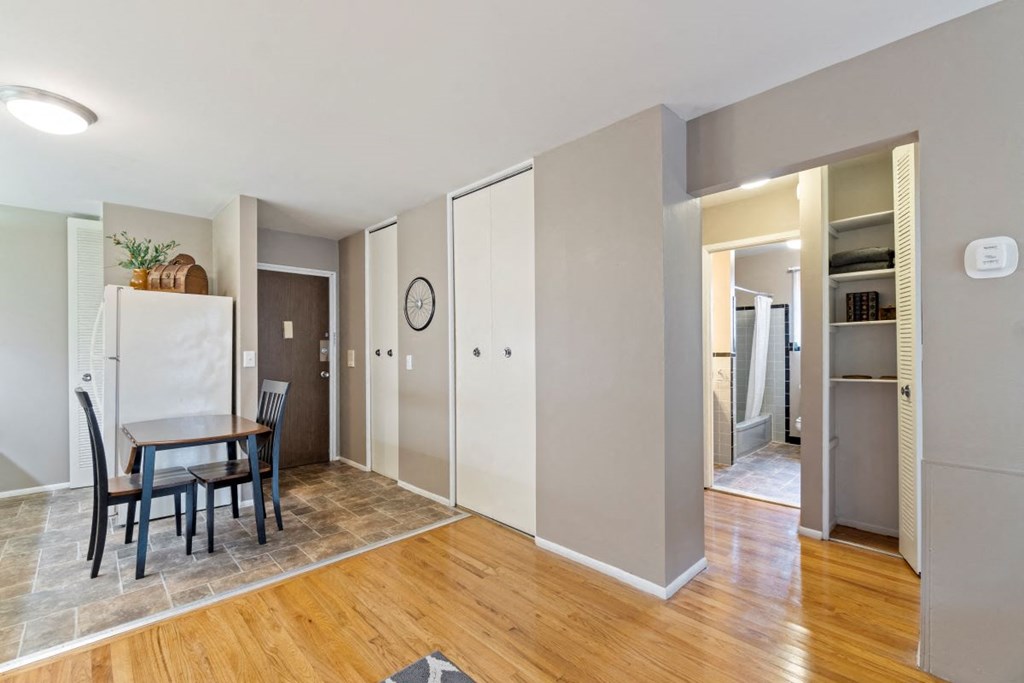a dining room with a table and a refrigerator