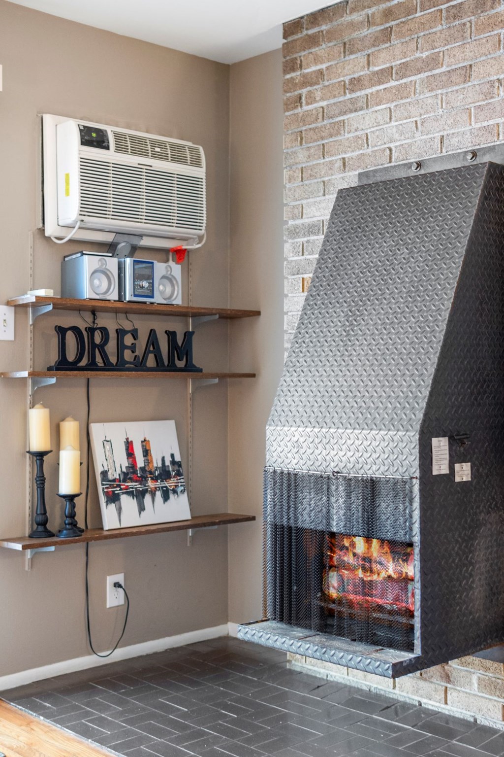 a living room with a fireplace and a dream sign on the wall