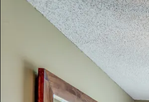 Bedroom with plush carpeting, a large window, and a ceiling fan.