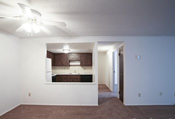 Living area overlooking hallway and kitchen with ceiling fans - Photo Gallery 7