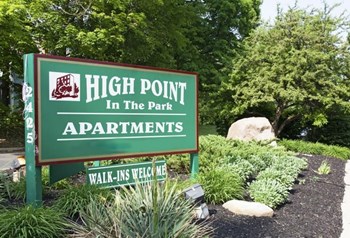 Green High Point in the Park monument sign - underneath smaller sign stating walk ins welcome surrounded by greenery and rocks. - Photo Gallery 14