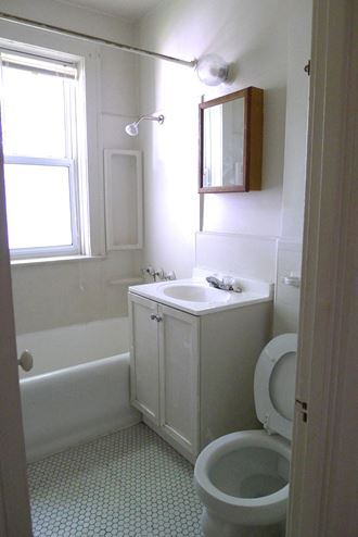 a small bathroom with a sink toilet and bathtub