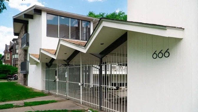 a white house with a fence and a gate