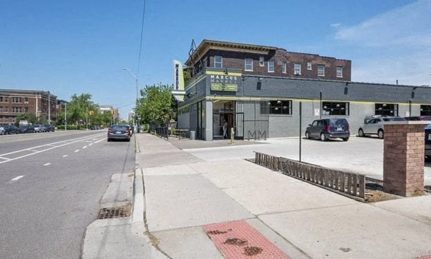 a building on the side of a street with cars