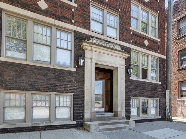 the front of a brick building with a door