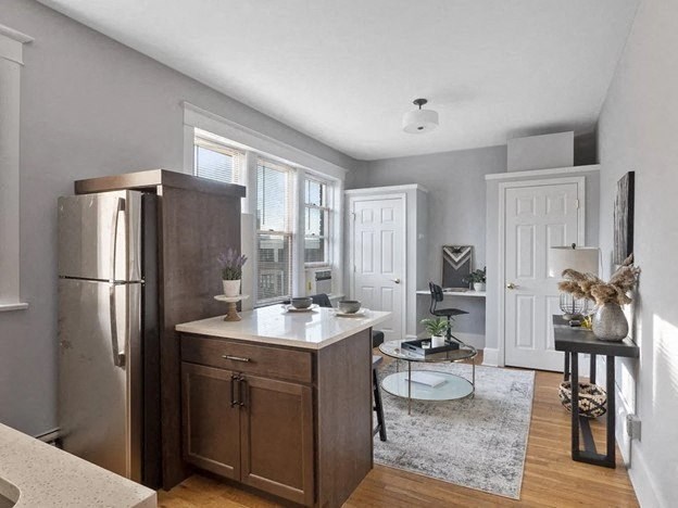 a kitchen with a refrigerator and a table