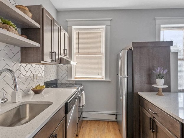 a kitchen with a sink and a refrigerator