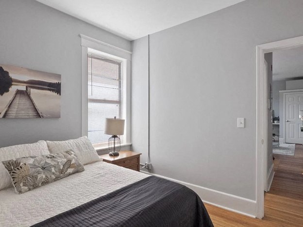 a bedroom with a bed and a window