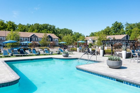 a resort pool with slides and buildings in the background