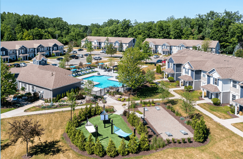 an aerial view of a community with houses and a swimming pool