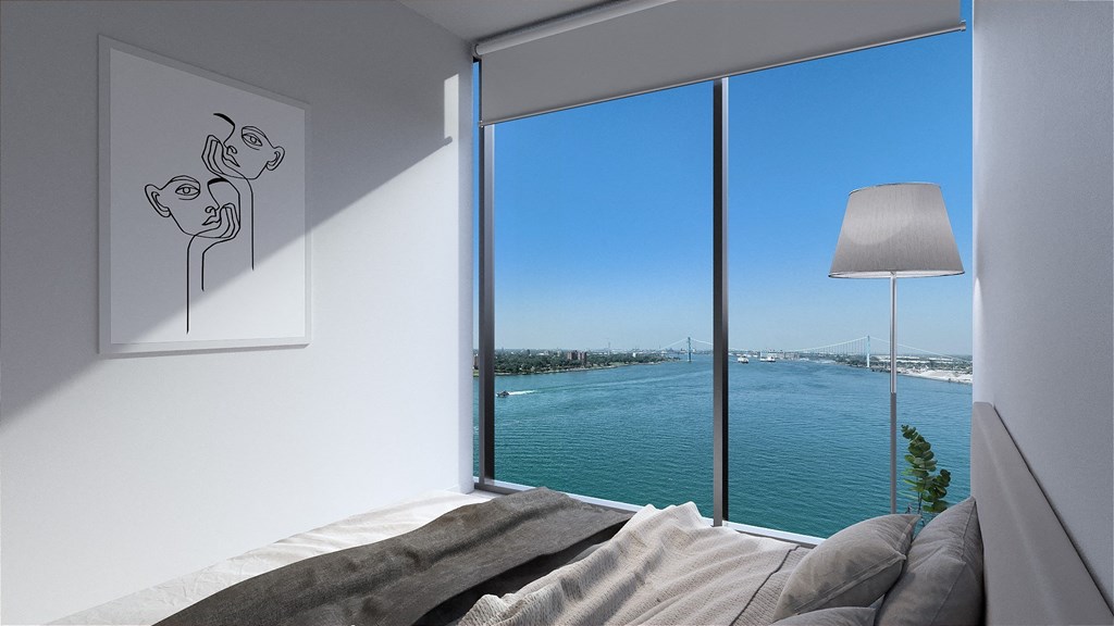 a bedroom with a large window and a view of the water