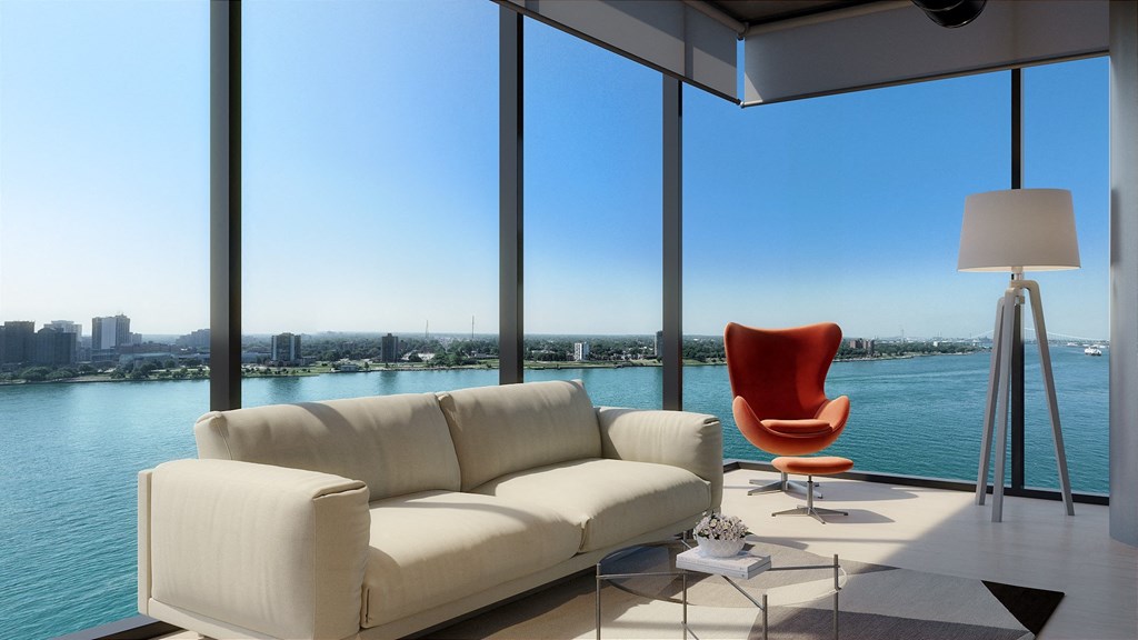 a living room with a large window and a view of a body of water