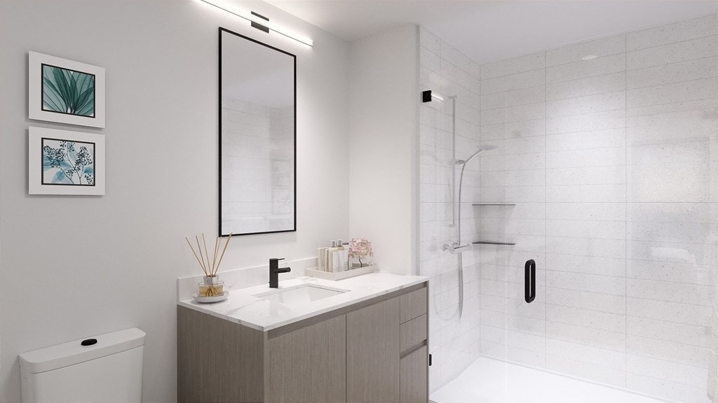 a bathroom with white walls and a white sink with a mirror above it