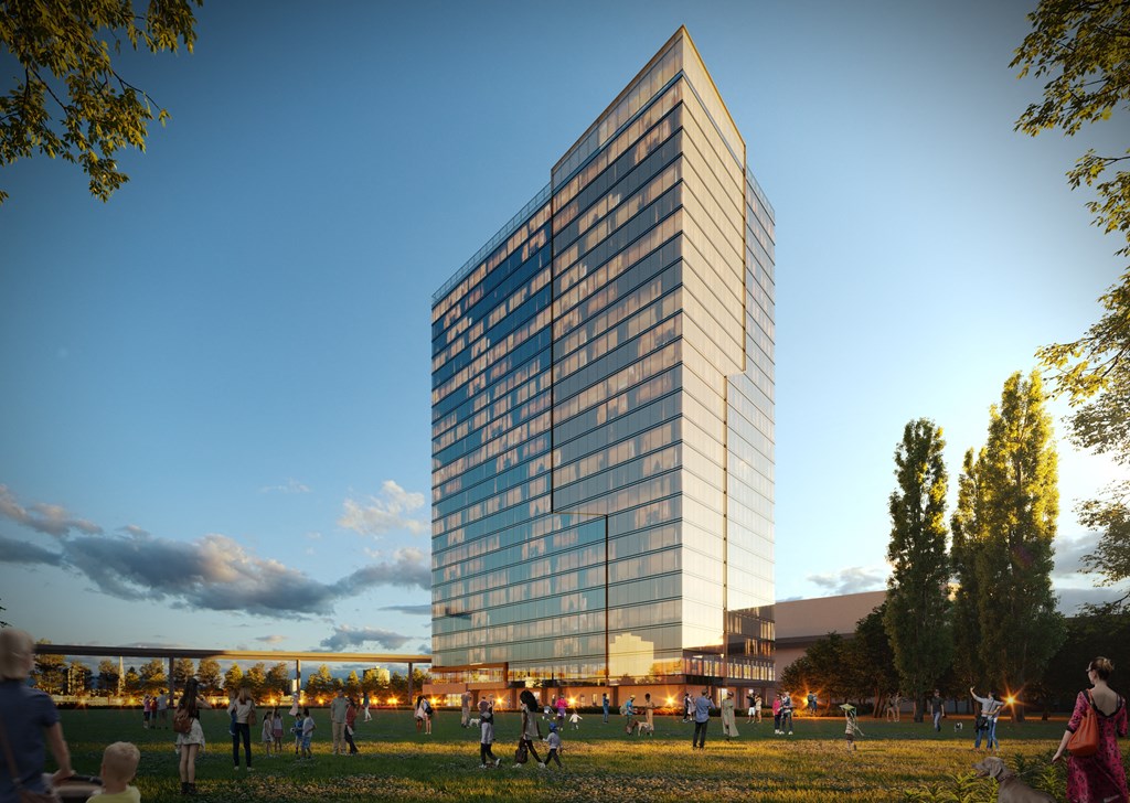 an aerial view of the building at dusk with people walking in the grass