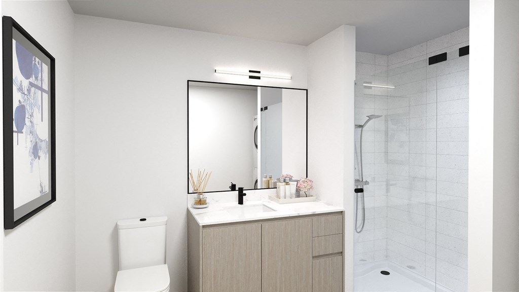 a bathroom with white walls and a white toilet next to a white sink with a large mirror