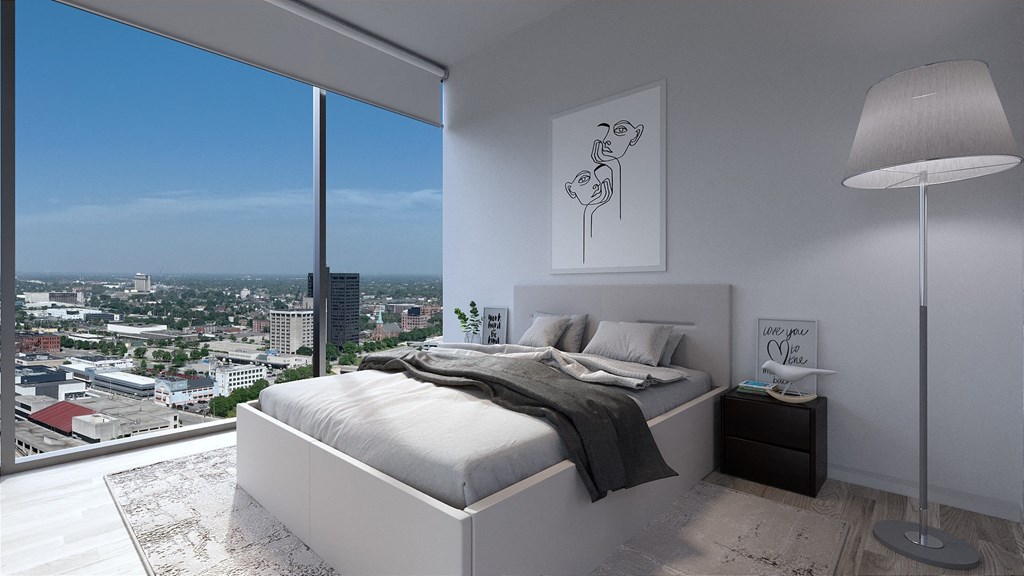 a bedroom with a large window and a city view