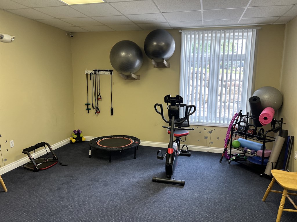 a fitness room with a trampoline and other exercise equipment