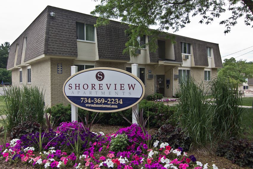 Shoreview Apartments Exterior monument sign with purple flowers - Photo Gallery 1