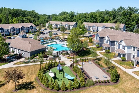 an aerial view of a community with houses and a swimming pool