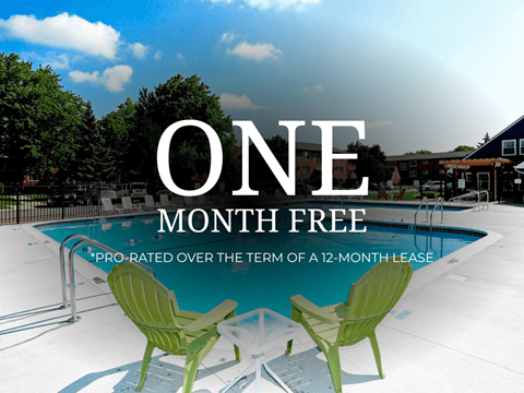 A pool with two green chairs and the text "ONE MONTH FREE" on a sunny day.